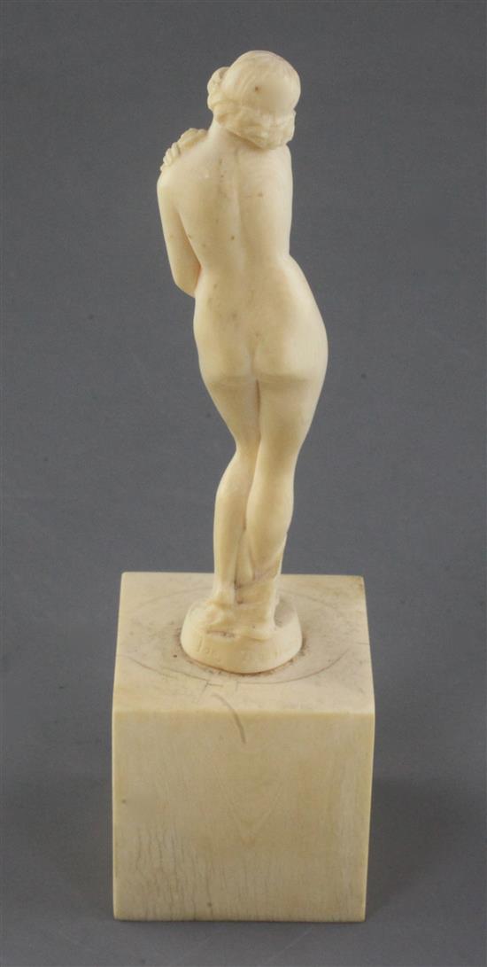 A Joe Descomps carved ivory figure of a standing nude woman holding a floral garland, height 5in.